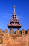 Mandalay Fort's almost 3km (2 miles) of walls enclose King Mindon's palace. The walls rise 8m (26ft).<br/><br/>

The palace was constructed, between 1857 and 1859 as part of King Mindon's founding of the new royal capital city of Mandalay. The plan of Mandalay Palace largely follows the traditional Burmese palace design, inside a walled fort surrounded by a moat.<br/><br/>

The palace itself is at the centre of the citadel and faces east. All buildings of the palace are of one storey in height. The number of spires above a building indicated the importance of the area below.<br/><br/>

Mandalay, a sprawling city of more than 1 million people, was founded in 1857 by King Mindon to coincide with an ancient Buddhist prophecy. It was believed that Gautama Buddha visited the sacred mount of Mandalay Hill with his disciple Ananda, and proclaimed that on the 2,400th anniversary of his death, a metropolis of Buddhist teaching would be founded at the foot of the hill.